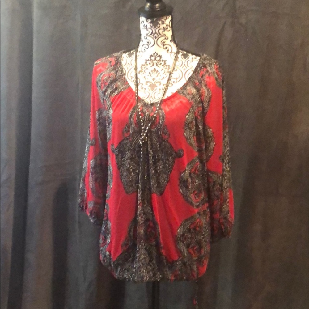 Sheer red blouse with black camisole